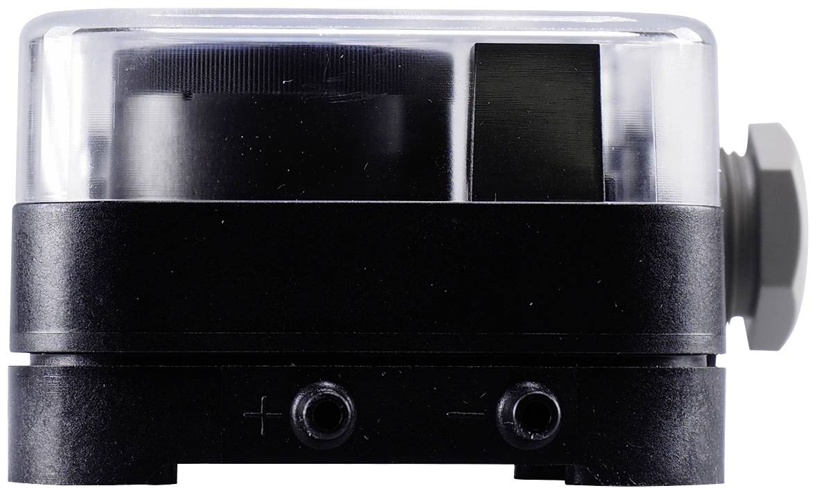 An electrical device with a black casing and a transparent upper section, with positive and negative terminals visible on the front.