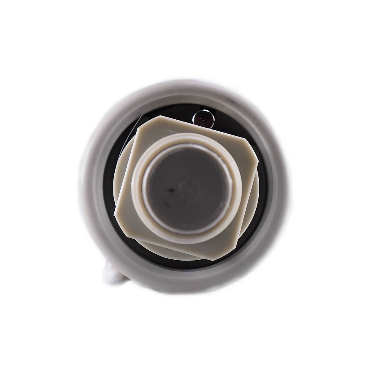 Close-up of white, round gear mechanism, with multiple interlocking elements and a dark centre.