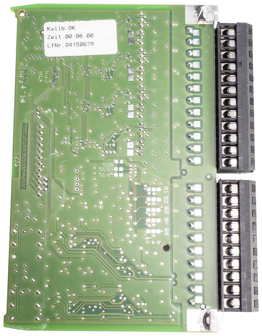 Green printed circuit board with electronic components and connectors. A white label with text is located in the top left corner.