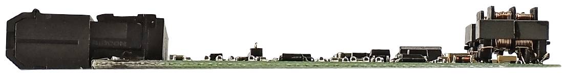 Flat electronic circuit board with multiple small black and copper-coloured components serving electrical distribution purposes.