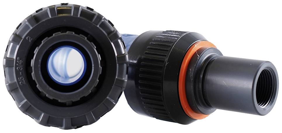 Close-up of a black plastic pipe with a threaded connection and orange sealing ring, suitable for plumbing or irrigation applications.