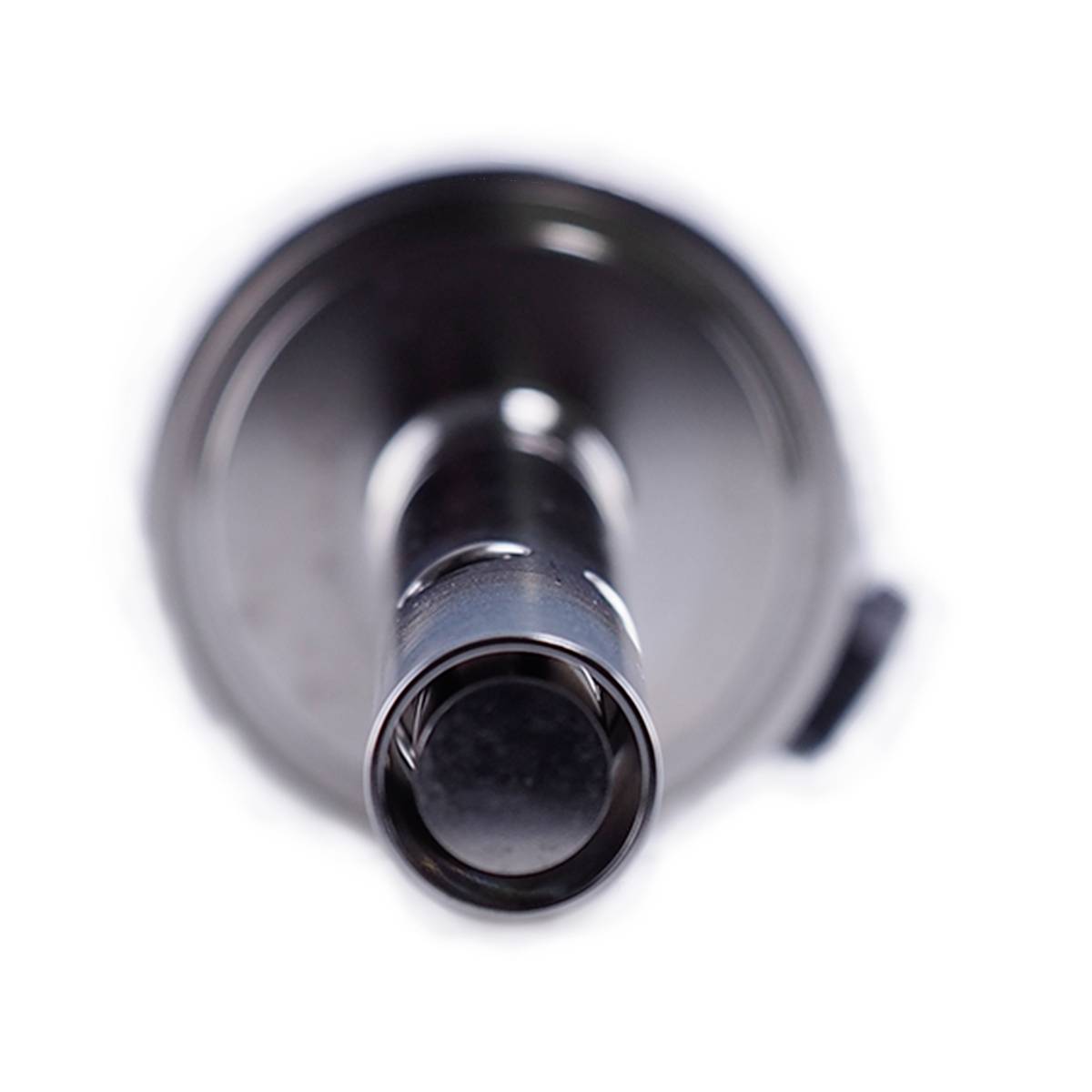 A microphone in close-up from the front. Silver-coloured, with a blurred background, focusing on the microphone membrane.