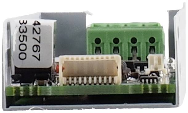 A green circuit board with electronic components, including terminal blocks and a white component with the inscription '42767 33500'.
