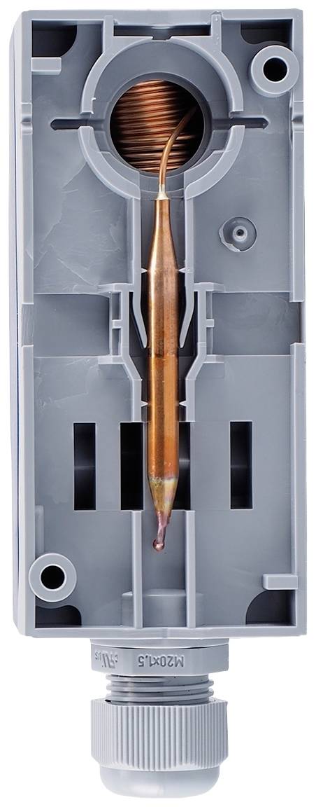 Open casing of an electrical sensor with an exposed copper coil in the centre, surrounded by grey plastic.