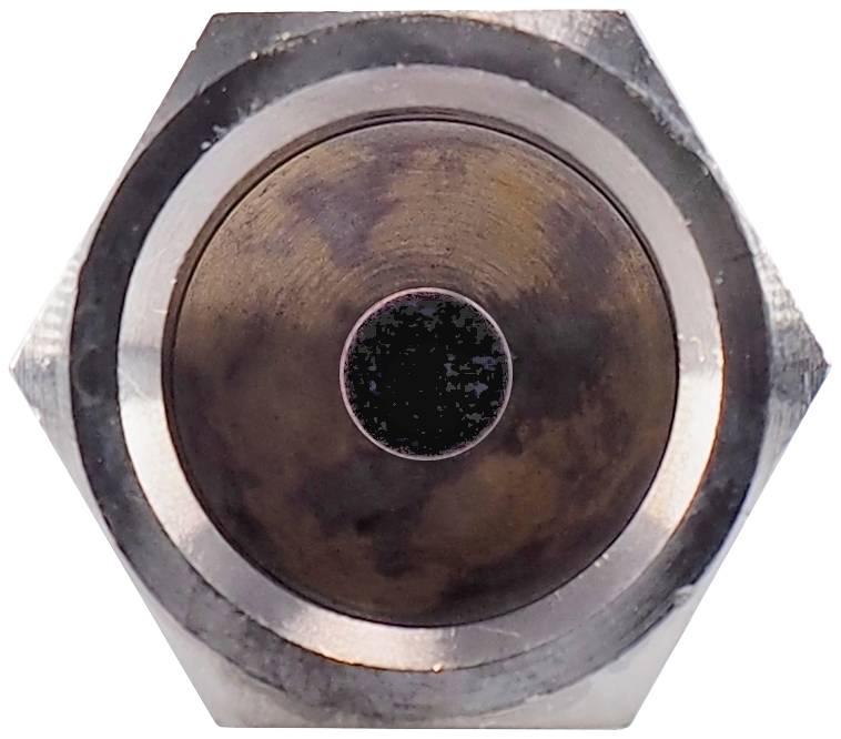 Close-up of a round metal surface in a hexagonal setting, possibly a technical component or part of a machine.