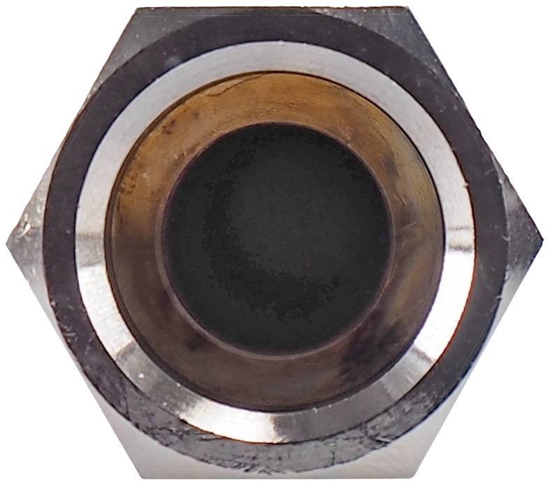 A metal screw nut in a close-up view from above, clearly showing the hexagonal shape and the circular internal thread.