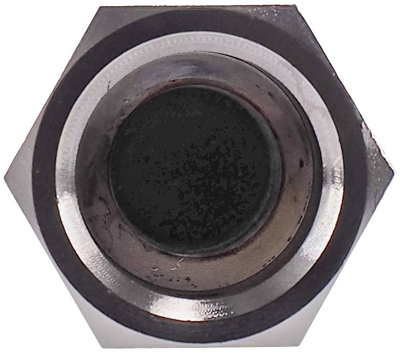 Metal nut viewed from above, hexagonal shape.