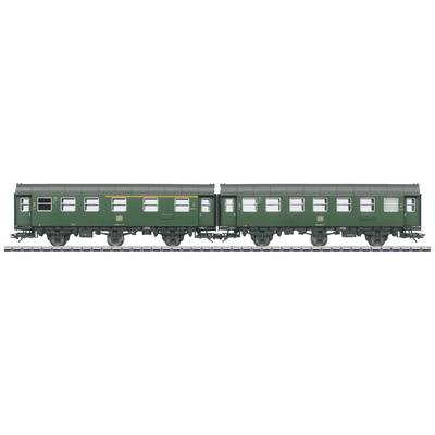 Two green railway carriages on a track, standing side by side, simple design without passengers or visible details.