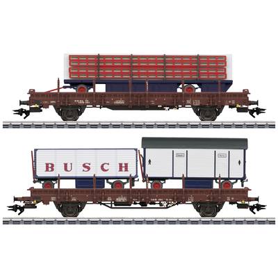 Two model railway wagons on tracks, loaded with detailed freight containers. Red containers on top, 'BUSCH' trailers below.