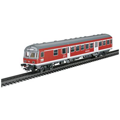 A red regional train carriage travels on model railway tracks. The vehicle bears the inscription 'Region' and a bicycle symbol.