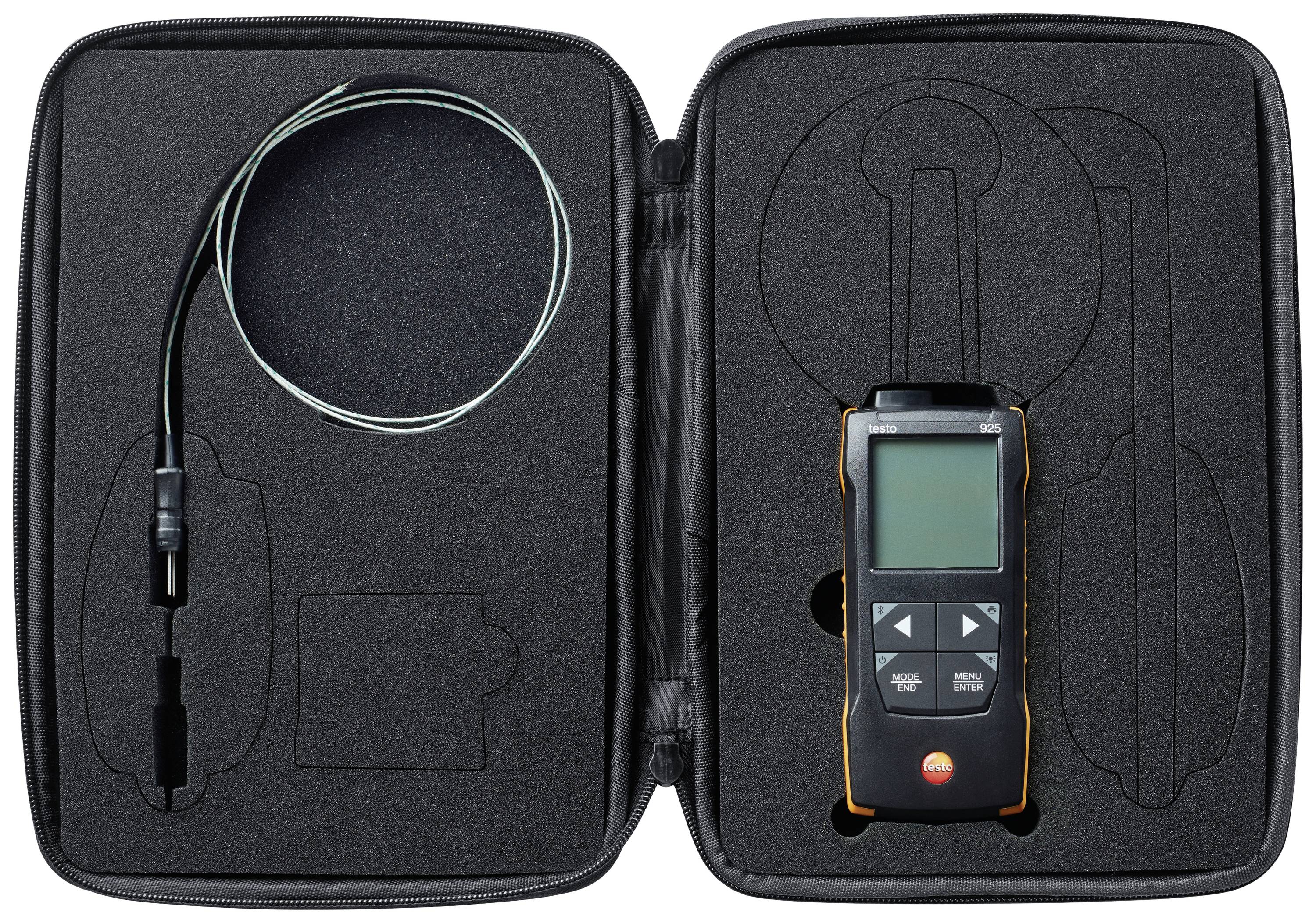 A suitcase with a measuring device on the right and cables on the left. The measuring device has a display and buttons. Cables for external connections.