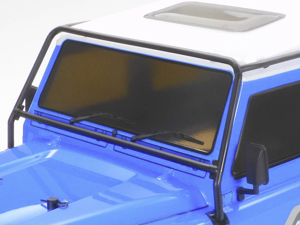 A blue and white model car with tinted windows and a black frame around the windscreen.