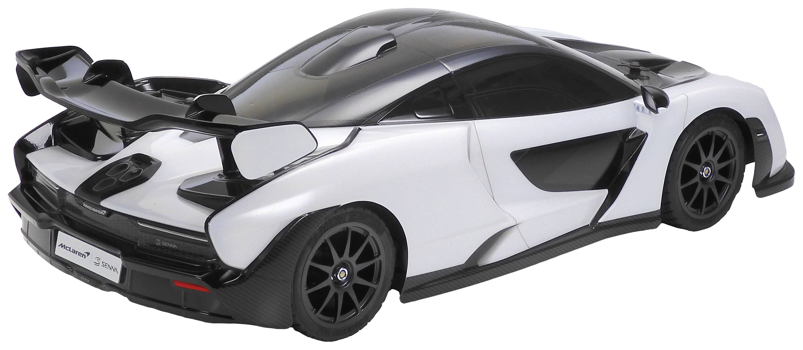 A white sports car with black details and a large rear spoiler is standing on a flat surface. The design is aerodynamic.