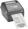 A grey label printer is outputting a package label with a barcode. The shipping and recipient details are visible on the label.