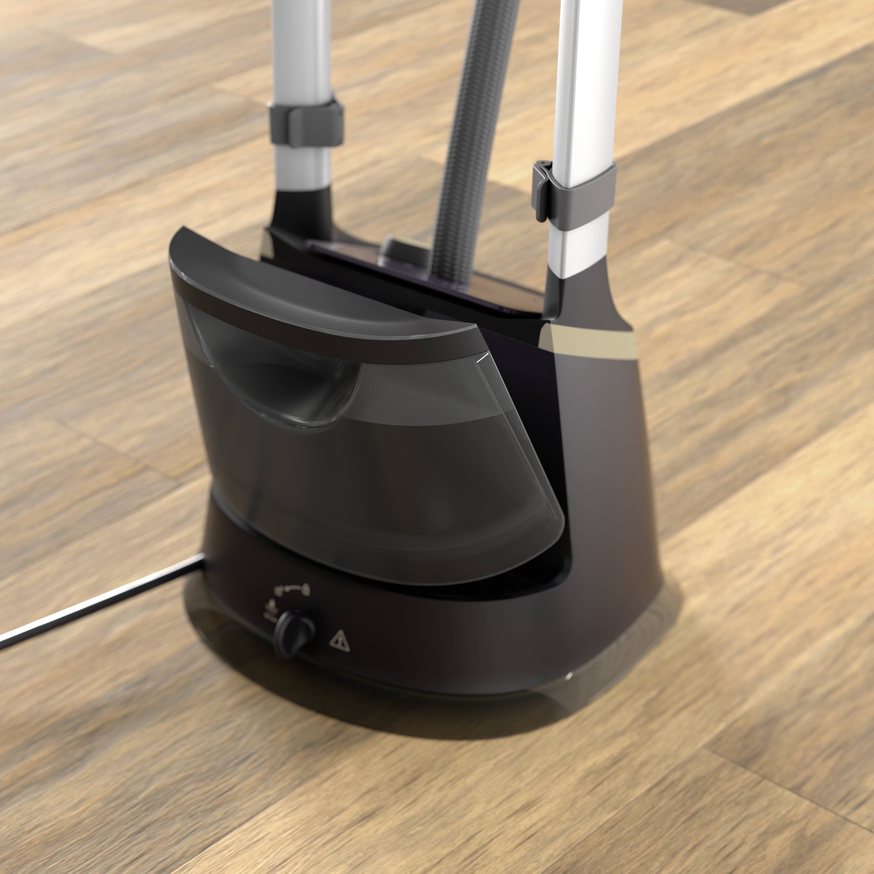 A steam cleaner is standing on a wooden floor. It has a black, curved water reservoir and a rotary switch at the base.