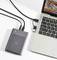 External hard drive and laptop connected by cable.