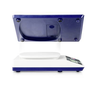 'Digital scale with display weighing an item. Weighing platform and mechanical elements are visible.'