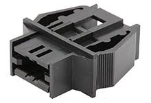 A black plastic component with a rectangular base form and structured sides, likely part of an electrical plug system.