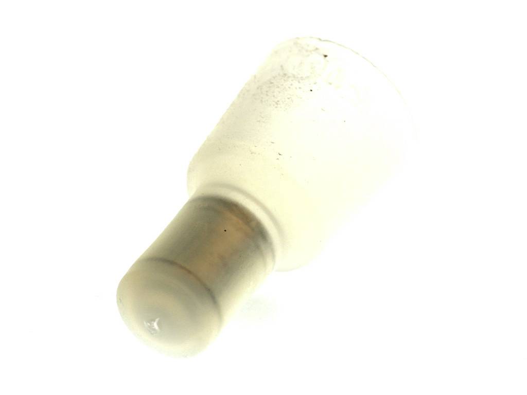 An opaque, cylindrical glass object with a wider top and narrower end, possibly an adaptor or stopper.