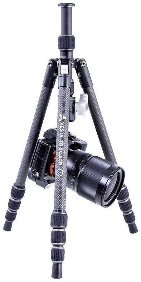 A carbon fibre tripod with a mounted camera demonstrates the adaptability for different angles in photography.