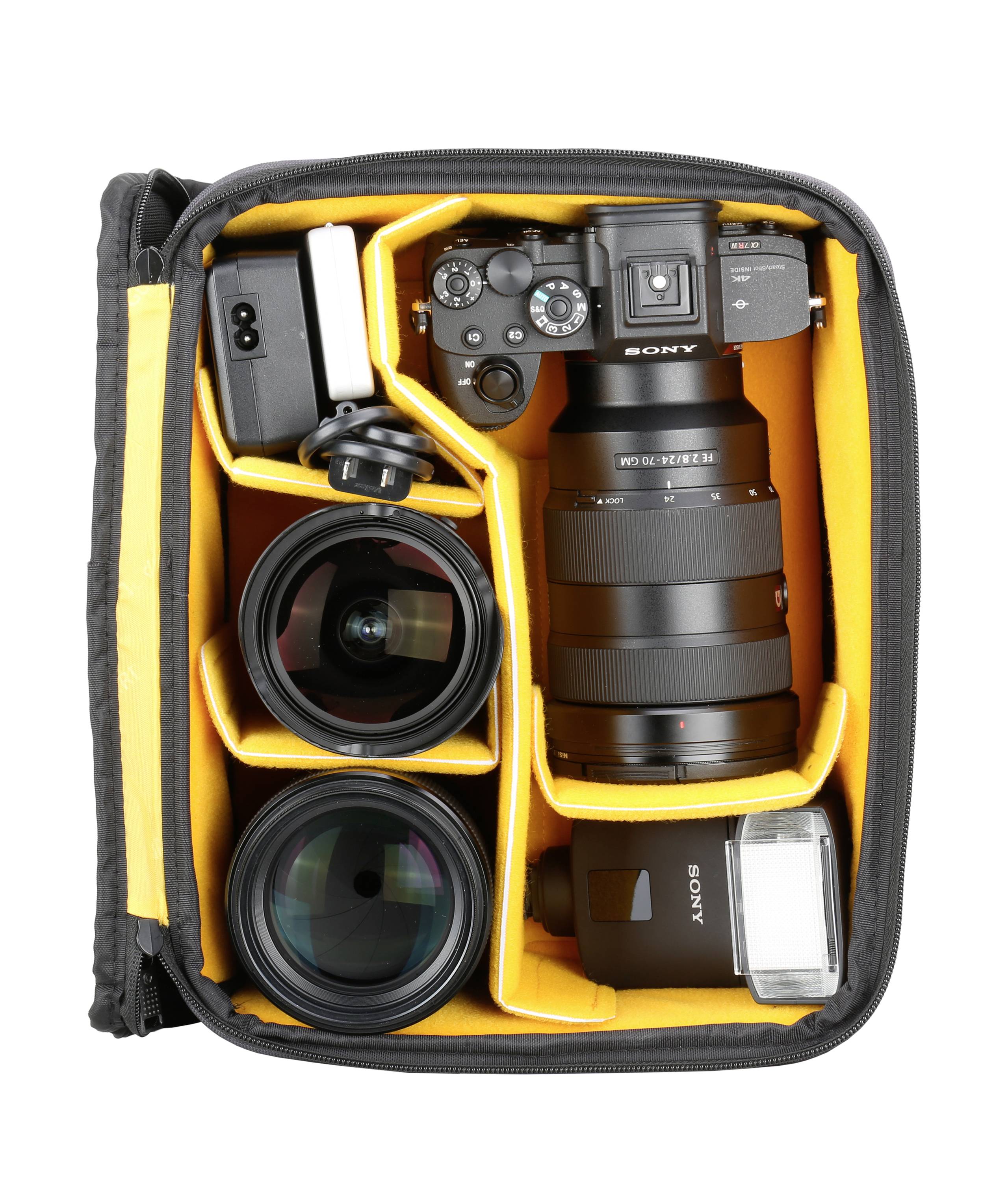 Camera bag containing a camera, three lenses and a flash unit, neatly arranged in padded compartments.