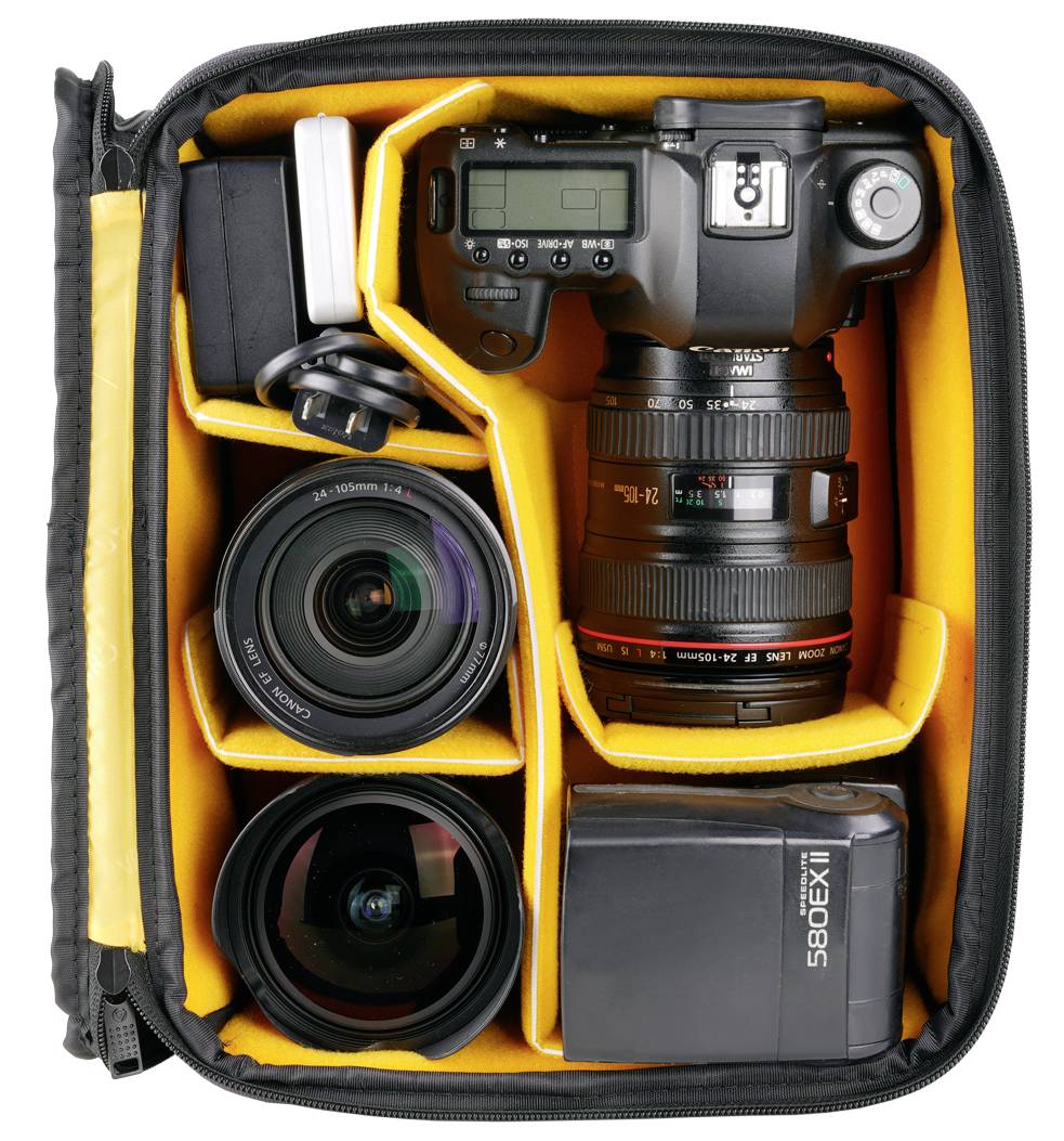 Camera equipment in a padded bag: a digital camera, two lenses, a flash, and accessory compartments visible.