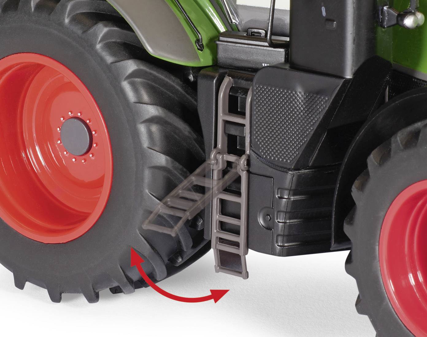 A step attachment on a large toy tractor with a red wheel and black casing. A red arrow indicates the folding movement of the steps.