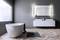 Modern bathroom with a freestanding bathtub, wooden flooring, large mirror and double washbasin.