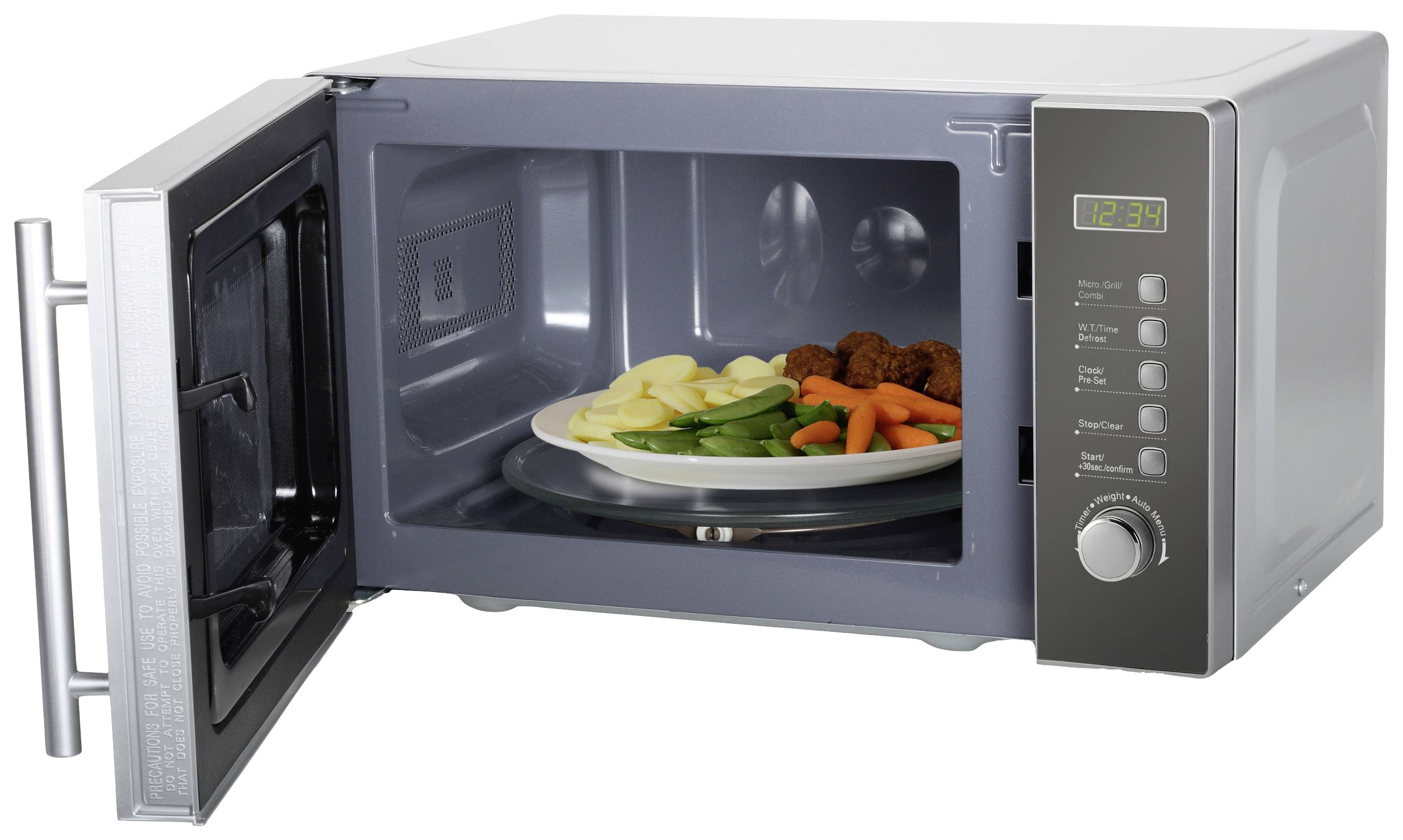 An open microwave oven with a plate full of vegetables and meatballs inside. Digital time display and control panel visible.