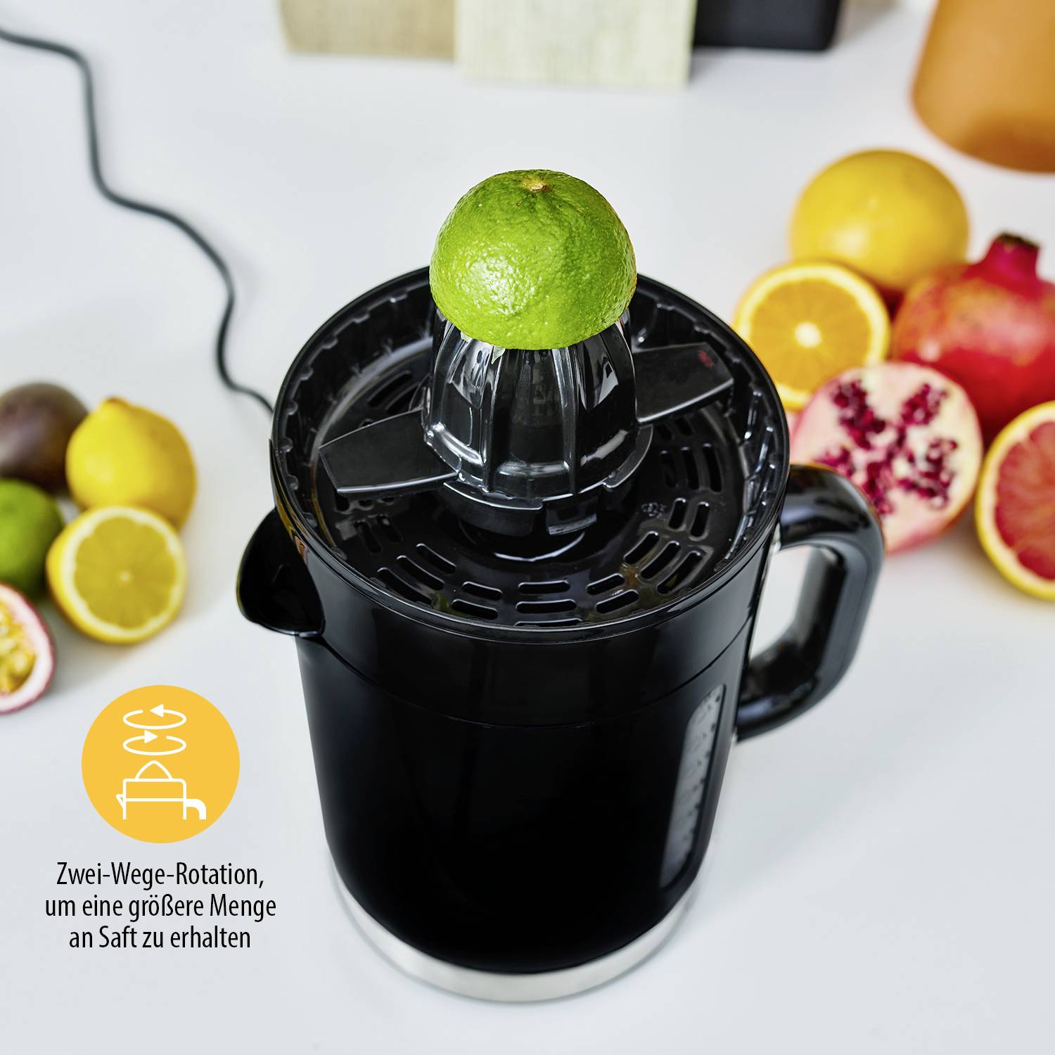 Juicer with Two-Way Rotation in action, surrounded by fresh fruits like oranges and pomegranate; Text: 'Two-Way Rotation... more juice'.