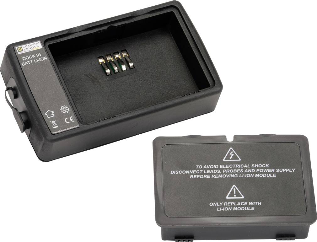 Battery docking station with four connection pins and removable cover. Electrical shock warning notices on the cover.