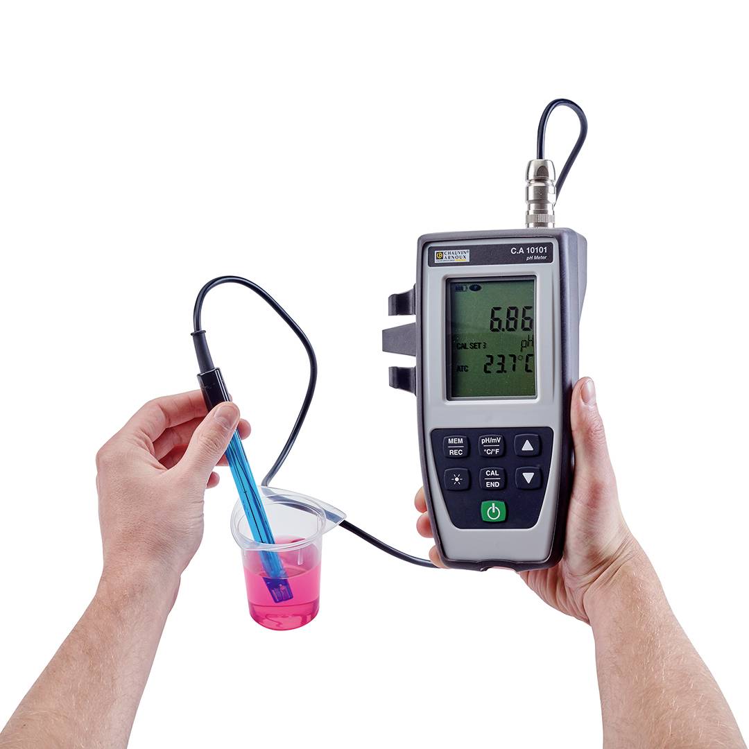 A hand is holding a pH metre, measuring in a pink liquid container. The display shows pH 5.86 and 23.7°C.