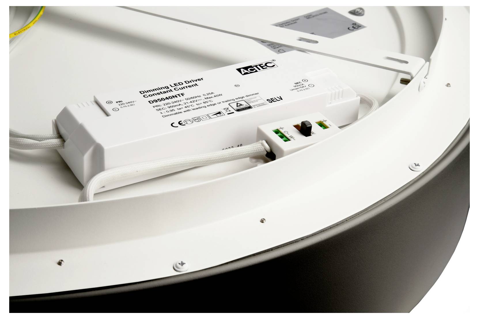 Close-up of an LED light fixture housing with an AGTEC constant-current LED driver and wiring inside the circular frame.