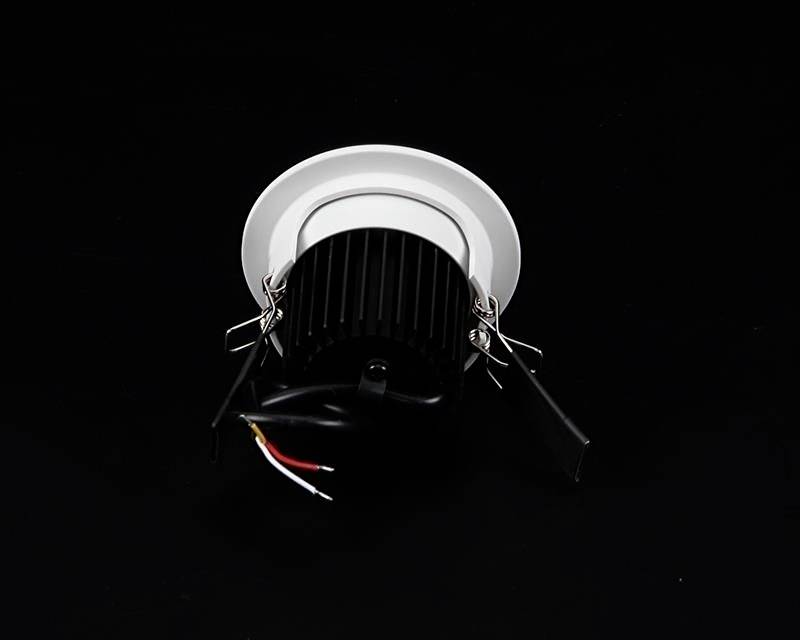 Round LED recessed spotlight with a black heatsink and visible cables, positioned on a black background.