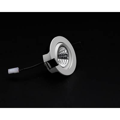 Round, silver recessed light with live cable on a black background.