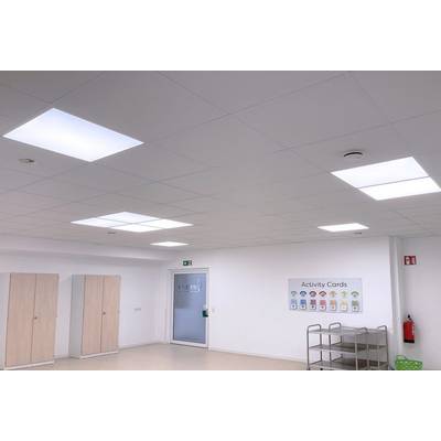 A bright room with white walls and ceiling. On the left are wooden cupboards, and on the right is a wall poster with 'Activity Cards'.