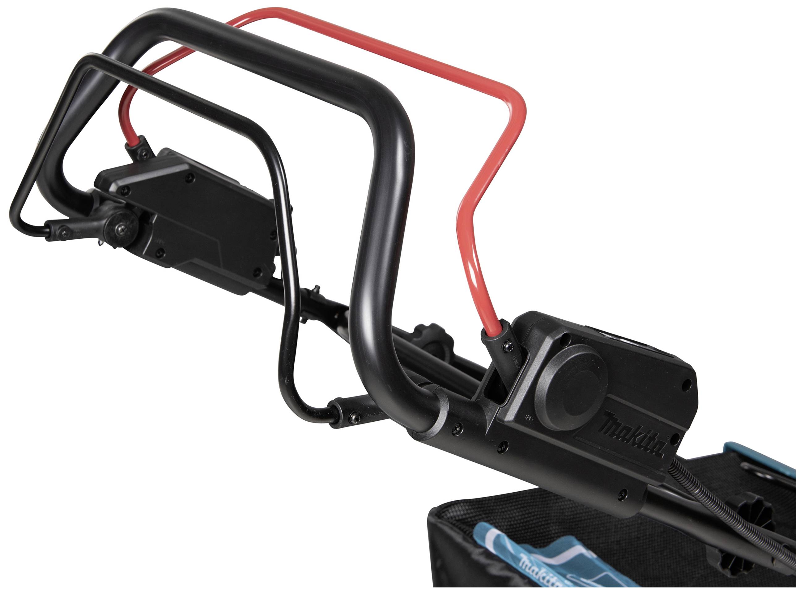 The image shows the handle of an electrical device with a black and red grip. It appears to be part of a larger machine frame.