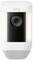 A white security camera with integrated speaker and light, branded 'ring', for external surveillance.