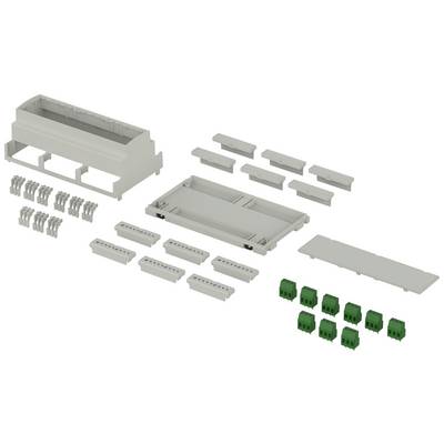 The image shows the individual components of a modular housing set, including plug-in terminals, cover plates, and other parts, before assembly.