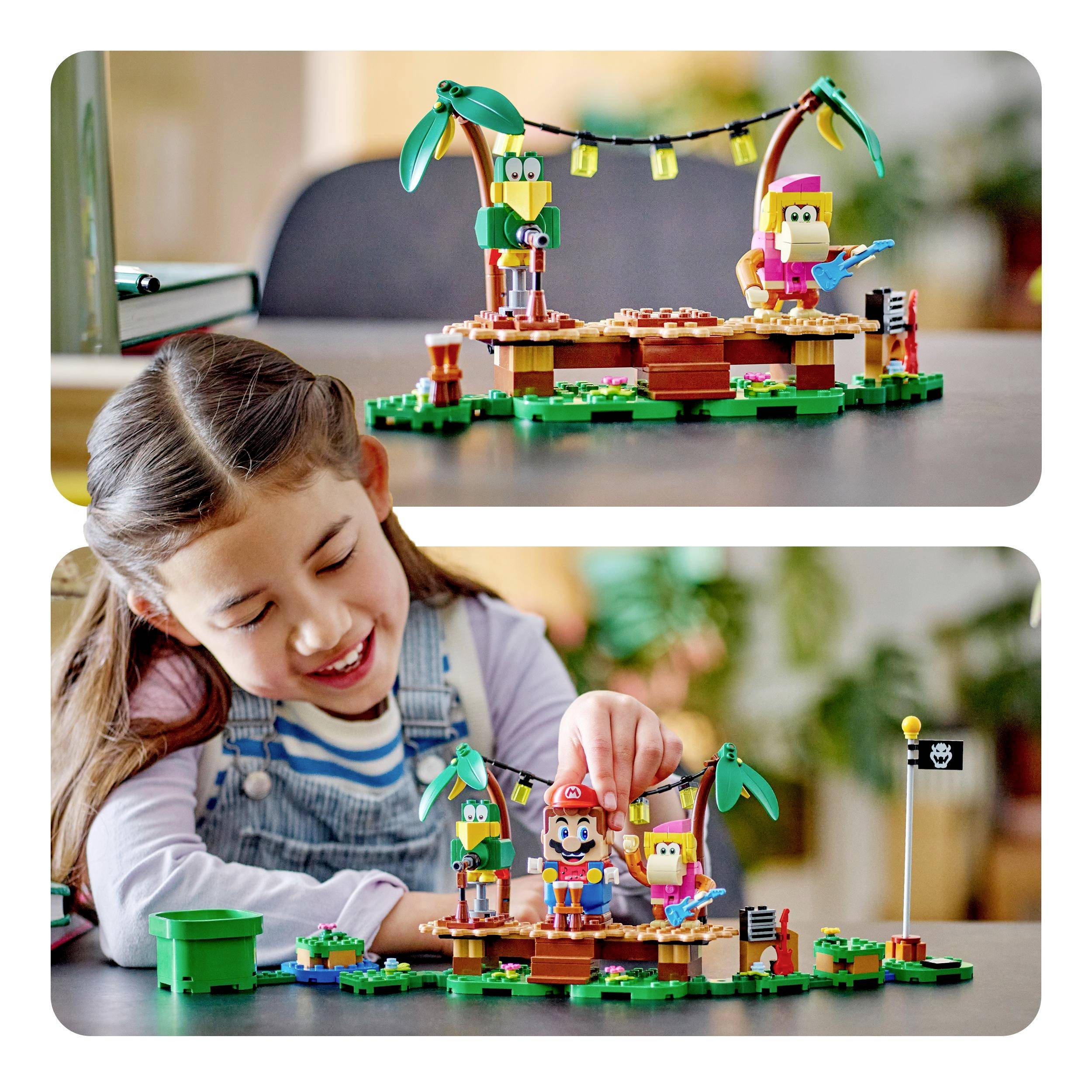 A child plays joyfully with a colourful construction set, comprising figures and a tropical landscape.