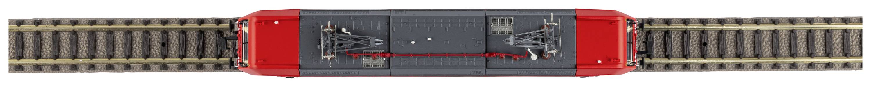 Red model locomotive on a track, viewed from above. It clearly shows the roof detail and track layout.