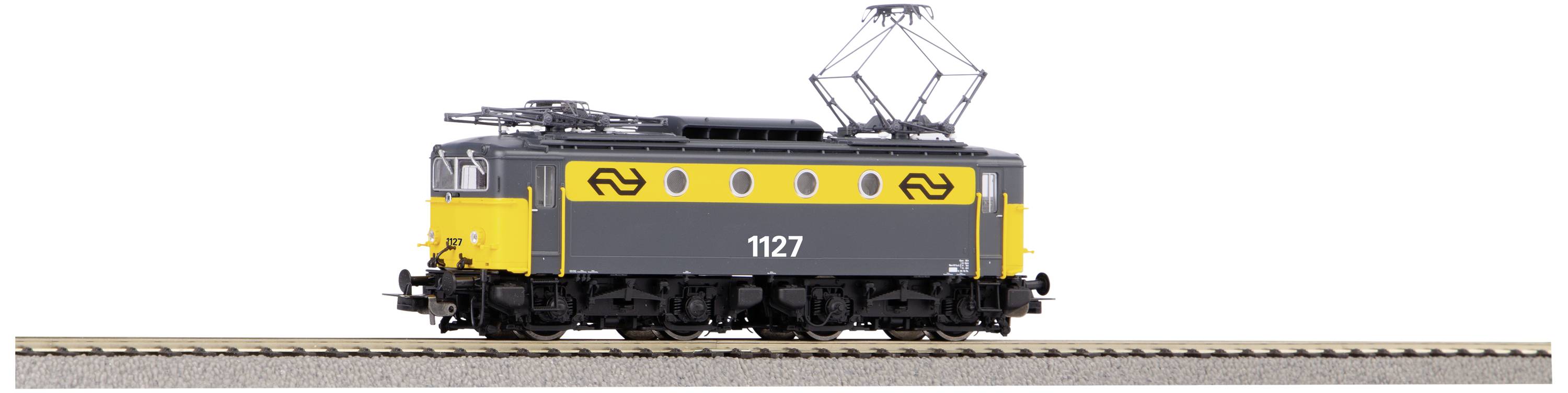 A black and yellow locomotive with the number '1127' is travelling on a railway track.