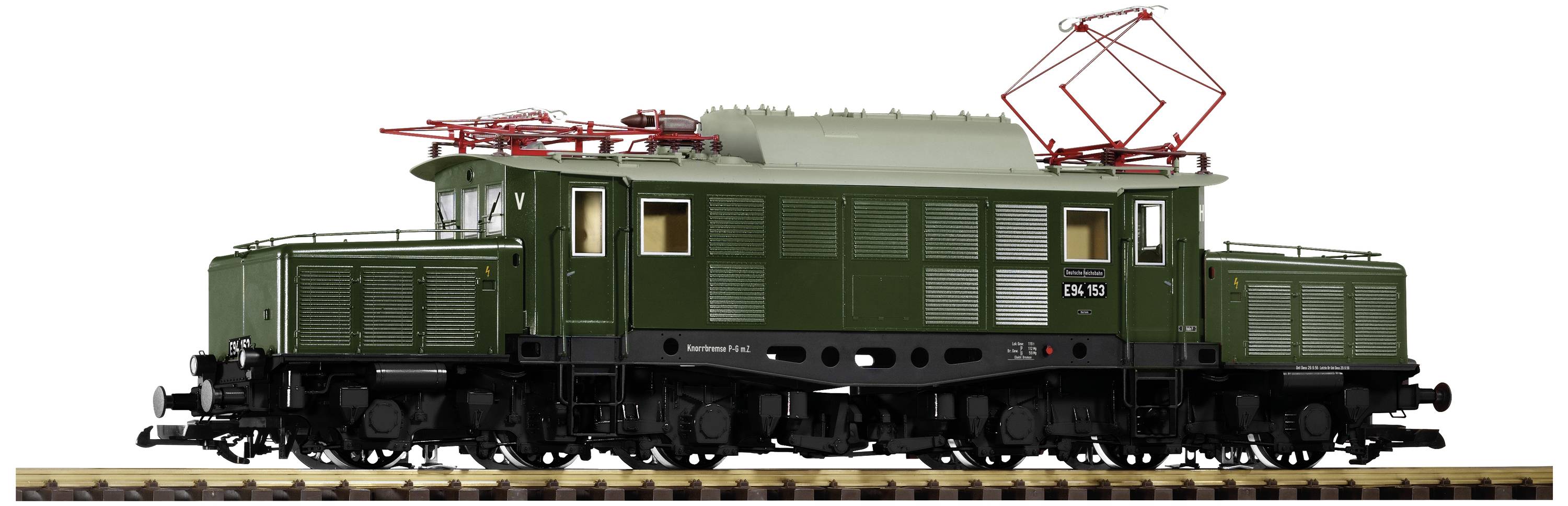 A green model of an electric locomotive stands on railway tracks. It has red pantographs on the roof and windows on both sides.
