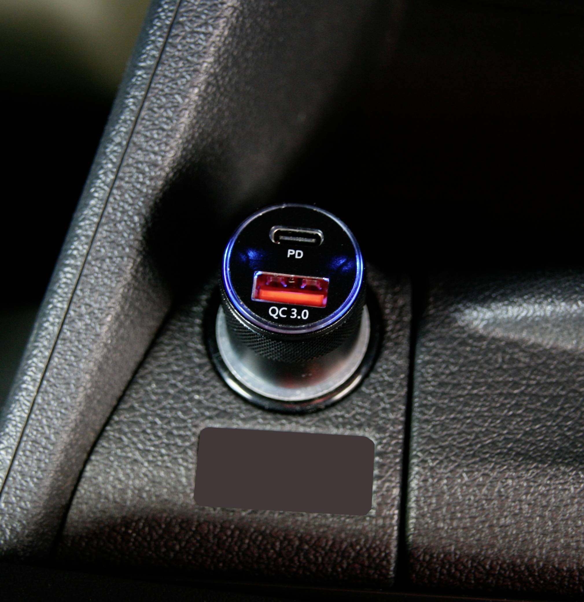A car adapter with USB ports, including a red port labelled 'QC 3.0' and a second port labelled 'PD'.