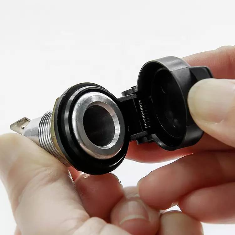 A person is holding an open cigarette lighter from a vehicle, showing the interior of the holder.