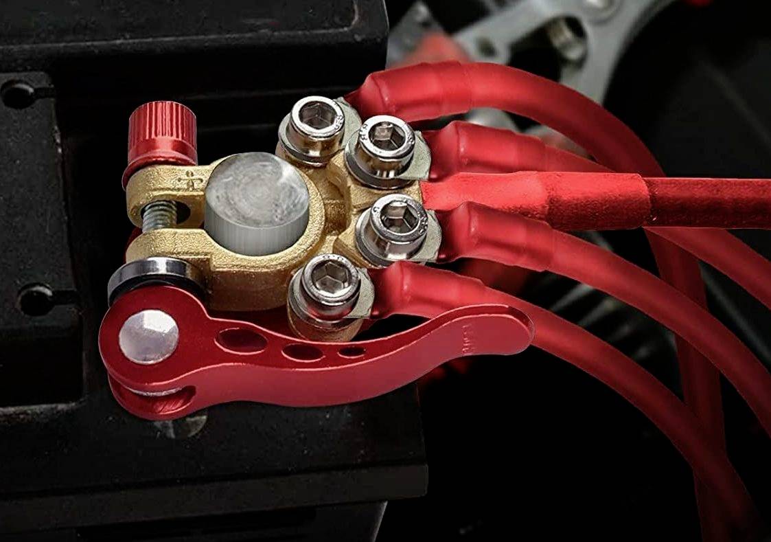 Red bicycle frame lock with quick-release lever, fastened to a round metal component. Several red cables run across it.