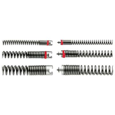 Various metal springs in a row, some with red markings, demonstrate differences in winding and design.