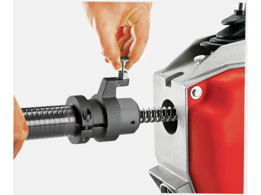 'A person using a safeguard to attach a flexible hose to a mechanical fitting in a device, ensuring secure connection and safety.'
