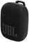 A portable, black JBL speaker with buttons for volume, playback, and the distinctive JBL logo embossed on the front.