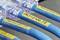 Close-up of blue cables with yellow labels in a network connection. The labels have numbers for identification.